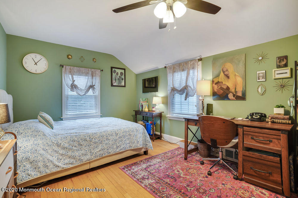 300 Spring Street Red Bank, NJ 07701 - Photo 19 of 25 a bedroom with a bed and a chandelier