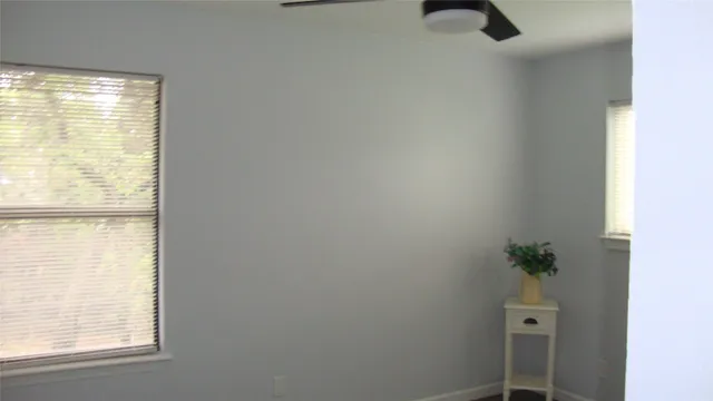 a view of a small space with wooden floor and a window