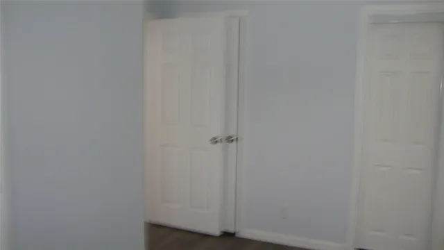 a bathroom with a granite countertop toilet sink and mirror