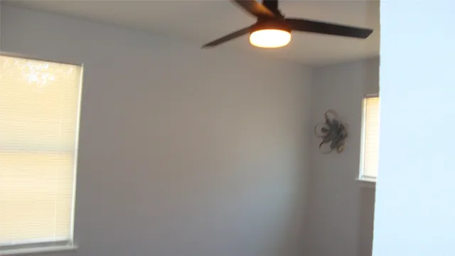 a bathroom with a shower curtain and a window