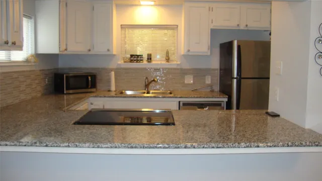 a kitchen with a refrigerator a stove and a cabinets