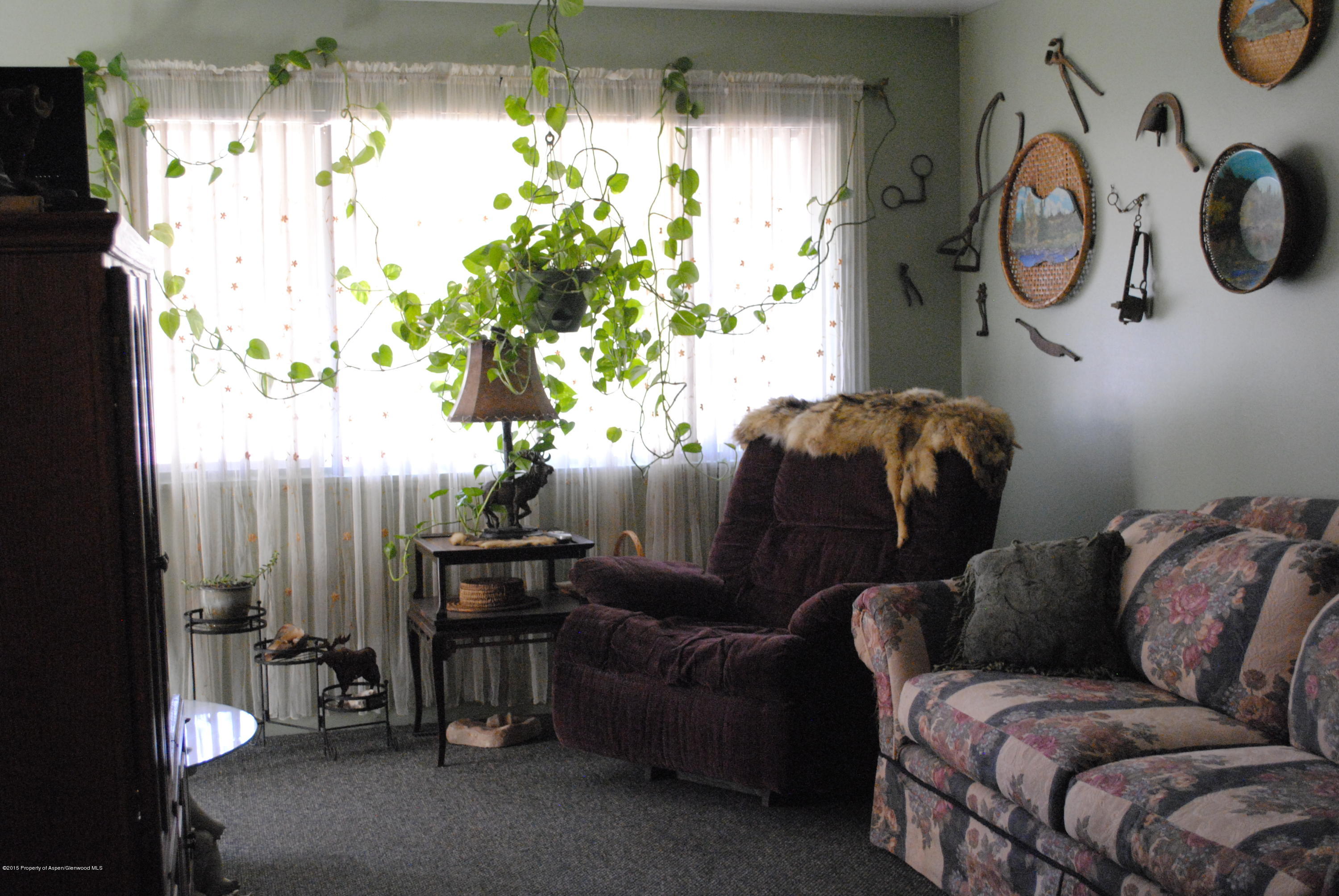 128 West 3rd Street Rifle, CO 81650 - Photo 3 of 16 a living room with furniture and a large window