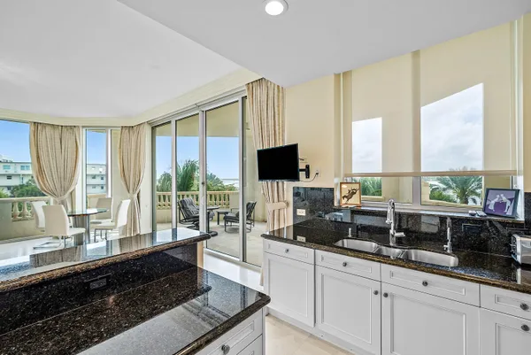 a living room with large window a flat screen tv and a large window