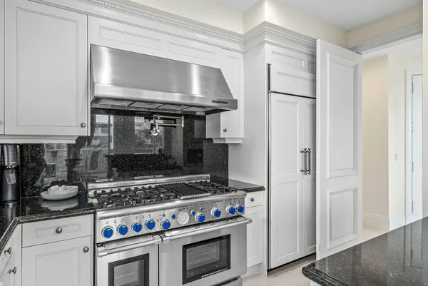 a stove top oven sitting inside of a kitchen