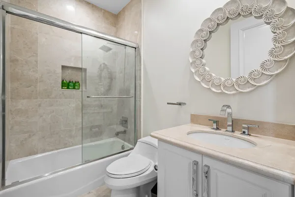 a bathroom with a sink a toilet and a mirror
