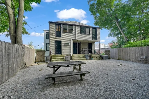 a view of a house with backyard and sitting area