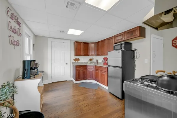 a kitchen with stainless steel appliances a refrigerator sink and wooden cabinets