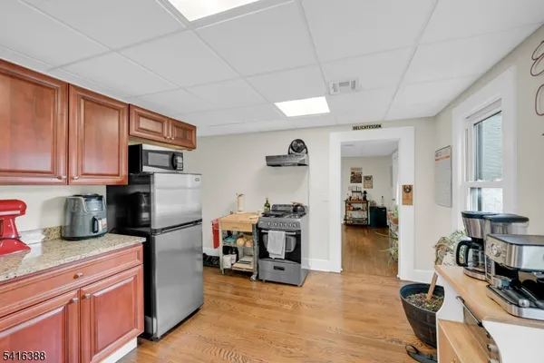 a living room with furniture a flat screen tv and kitchen view