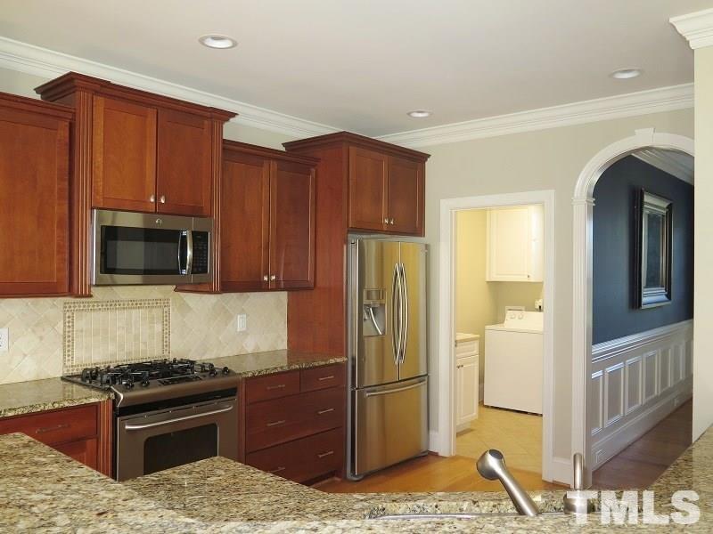 519 Chapanoke Road Raleigh, NC 27603 - Photo 8 of 25 a kitchen with stainless steel appliances granite countertop a refrigerator stove and microwave