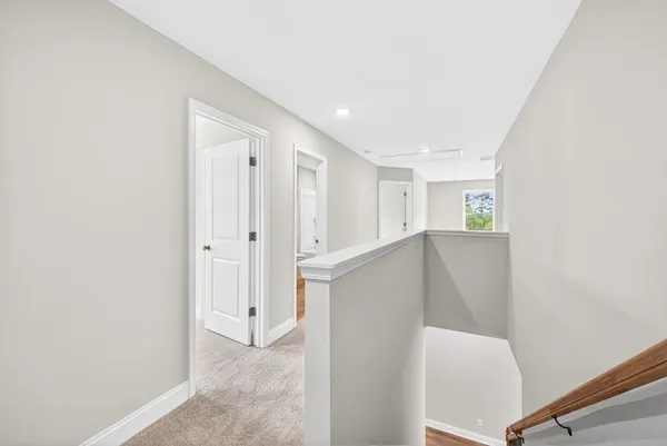 a view of a hallway with closet and wooden floor