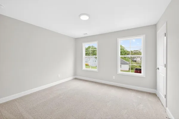 an empty room with window and a ceiling fan