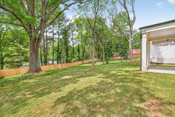 a view of a white house with a swimming pool and sitting area