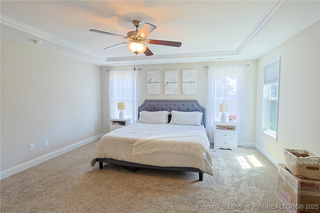 213 Sand Rock Road Fayetteville, NC 28306 - Photo 16 of 27 a bedroom with a bed and a chandelier