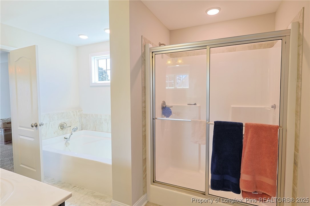 213 Sand Rock Road Fayetteville, NC 28306 - Photo 18 of 27 a bathroom with a glass shower door