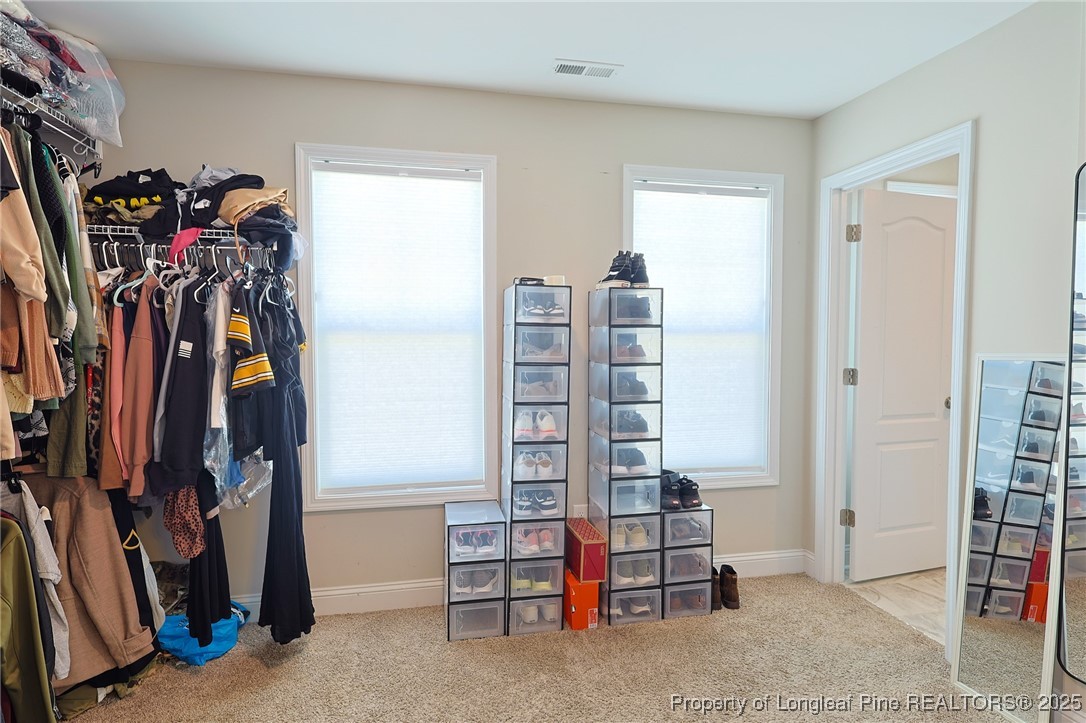 213 Sand Rock Road Fayetteville, NC 28306 - Photo 21 of 27 a view of walk in closet with clothes