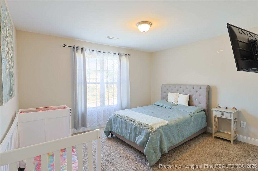 213 Sand Rock Road Fayetteville, NC 28306 - Photo 23 of 27 a bedroom with a bed and a window