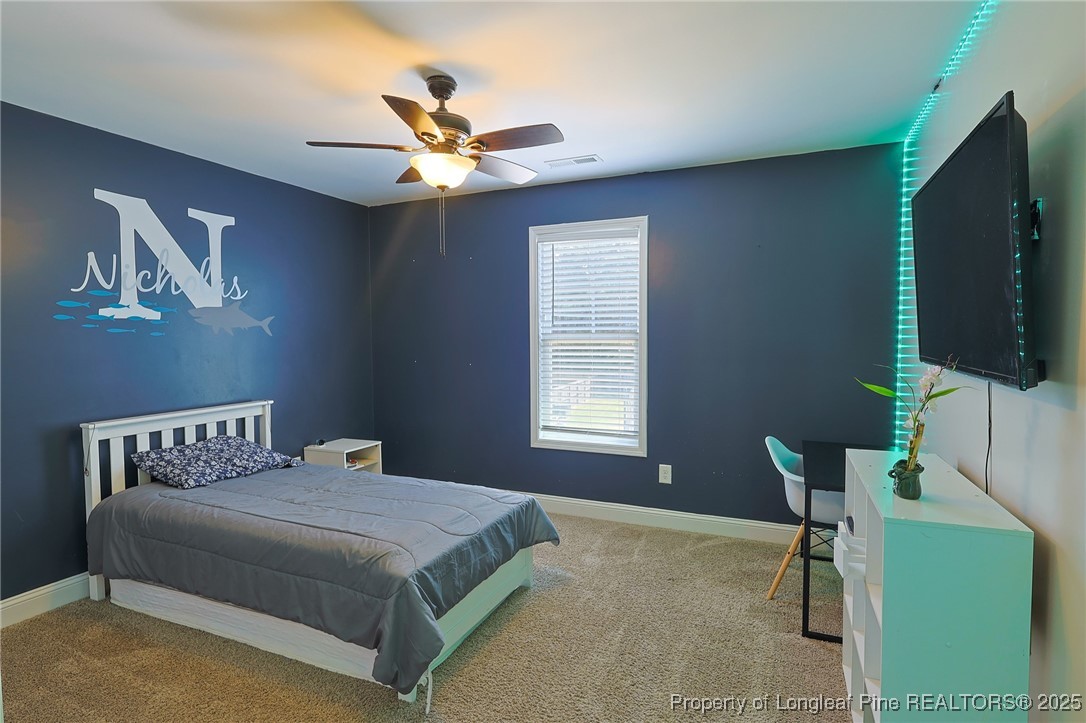 213 Sand Rock Road Fayetteville, NC 28306 - Photo 25 of 27 a bedroom with a bed tv and a window