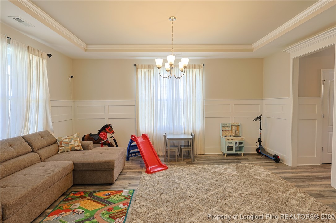 213 Sand Rock Road Fayetteville, NC 28306 - Photo 3 of 27 a living room with furniture and a chandelier