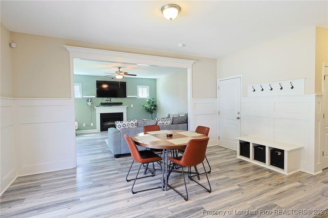 213 Sand Rock Road Fayetteville, NC 28306 - Photo 7 of 27 a view of a dining room with furniture and wooden floor
