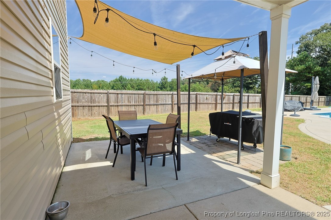 213 Sand Rock Road Fayetteville, NC 28306 - Photo 9 of 27 a view of a patio with a table chairs and backyard