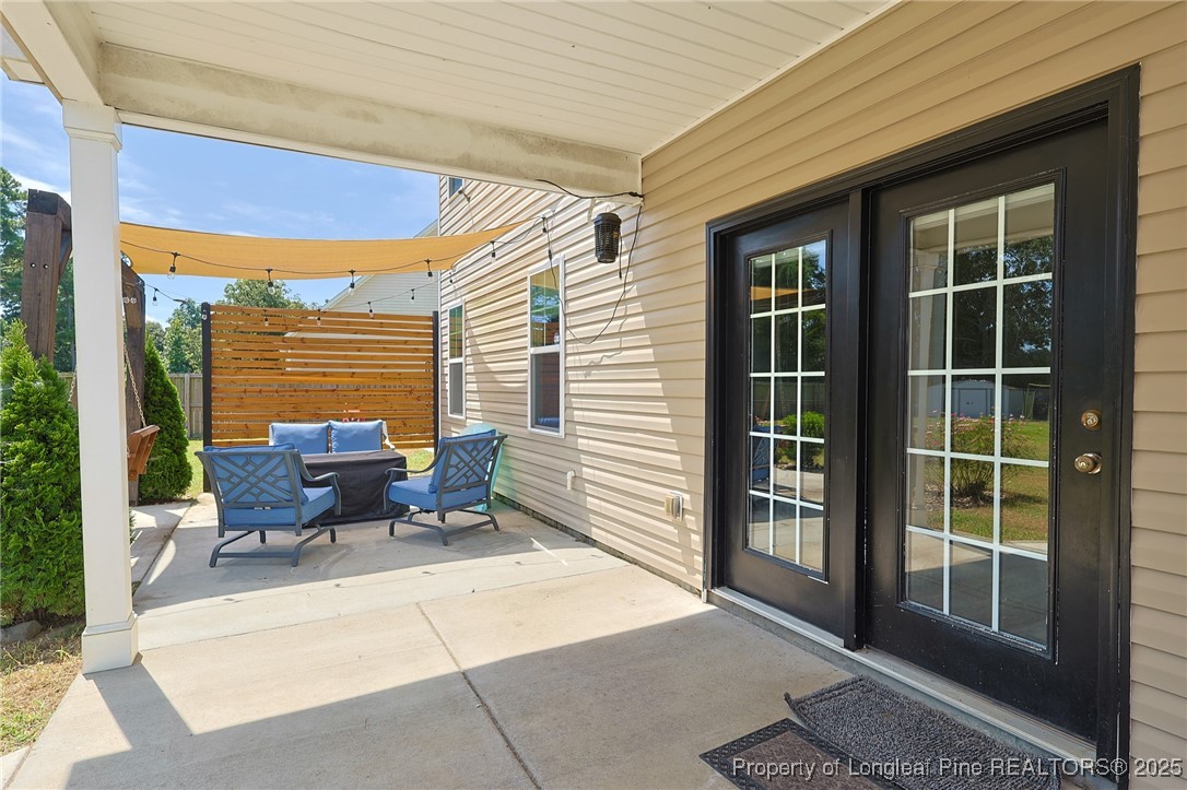 213 Sand Rock Road Fayetteville, NC 28306 - Photo 10 of 27 a balcony with furniture and outdoor space