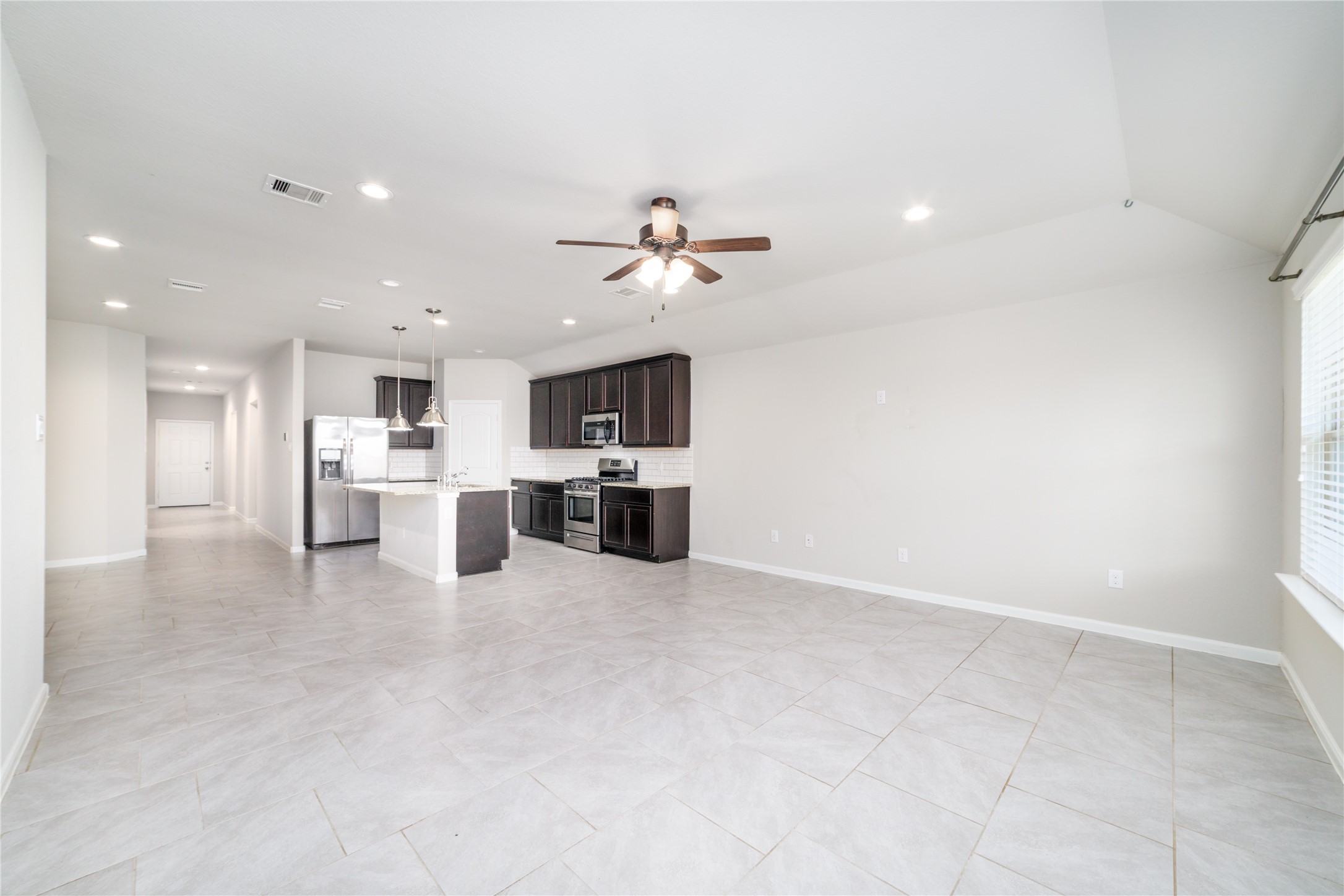 8307 Oakleaf Meadow Court Rosharon, TX 77583 - Photo 10 of 39 a view of kitchen with kitchen island a sink stainless steel appliances and cabinets
