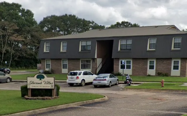 a car parked in front of a brick house