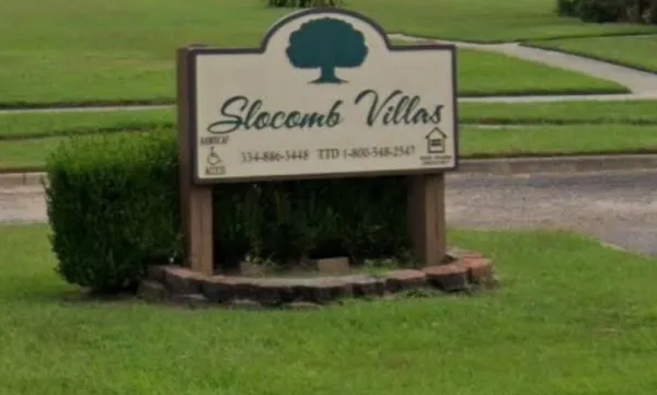 a view of outdoor space with sign board and garden