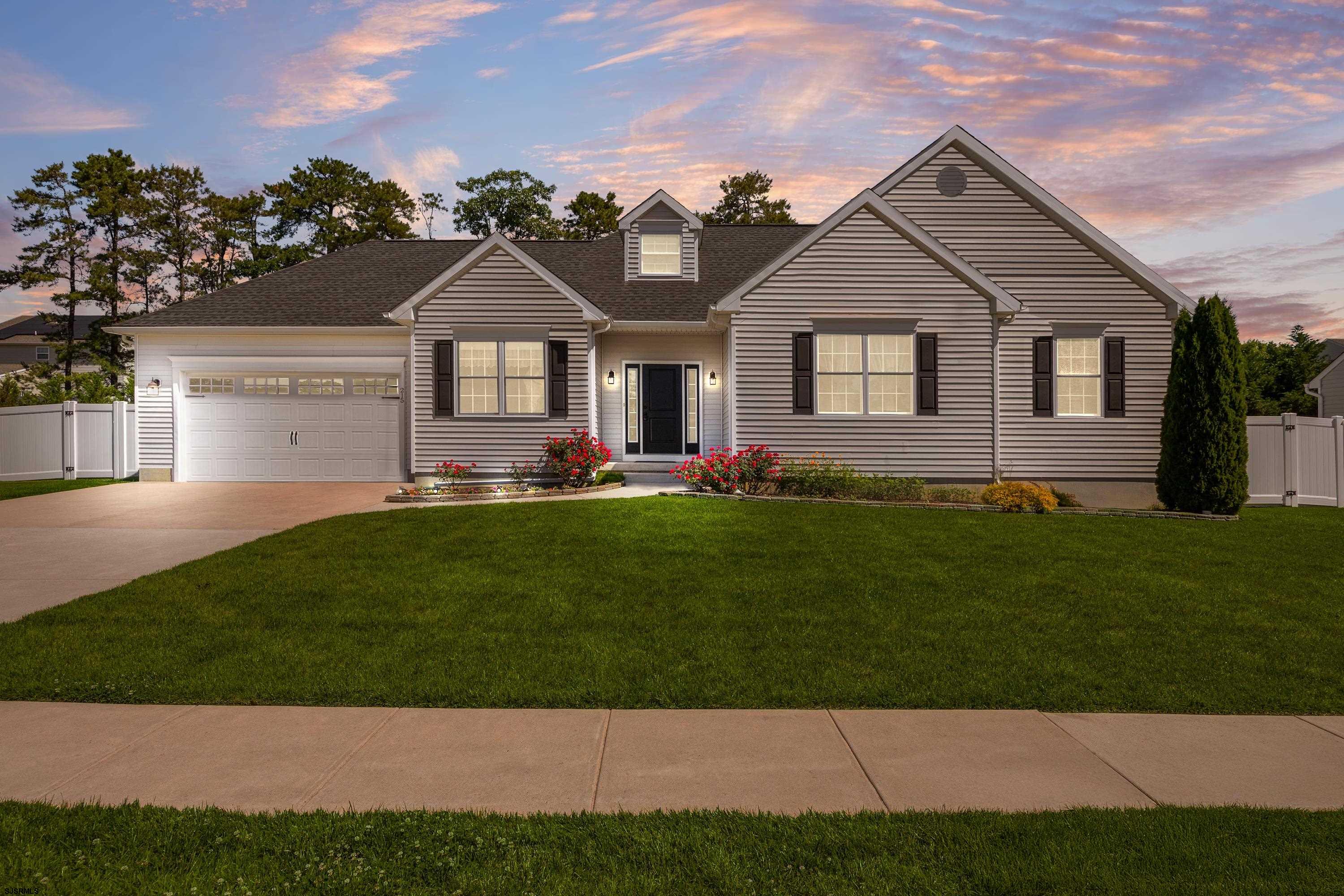 215 Surf Road Egg Harbor Township, NJ 08234 - Photo 28 of 31 a front view of a house with a yard and garage