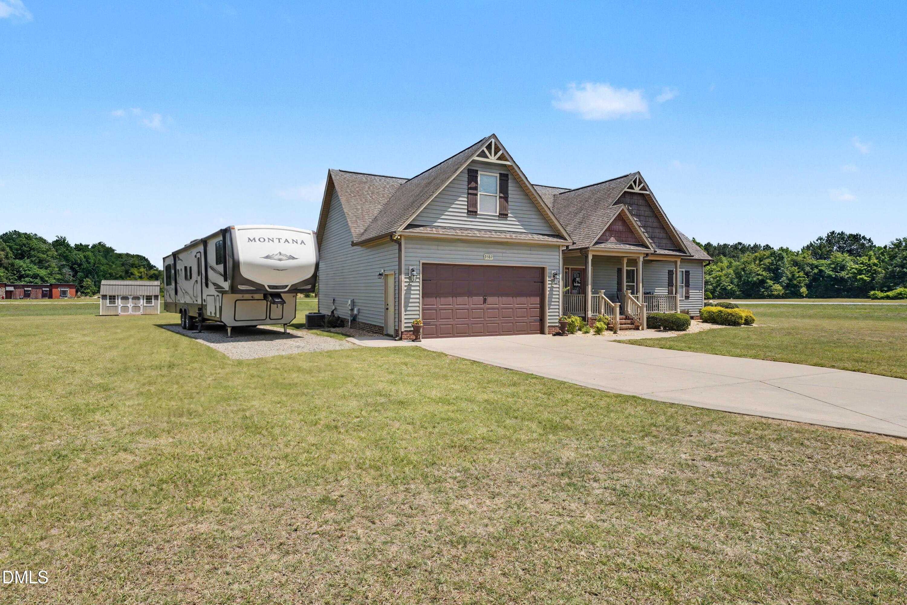 3587 Hannah Creek Road Benson, NC 27504 - Photo 1 of 43 a front view of a house with a yard and garage