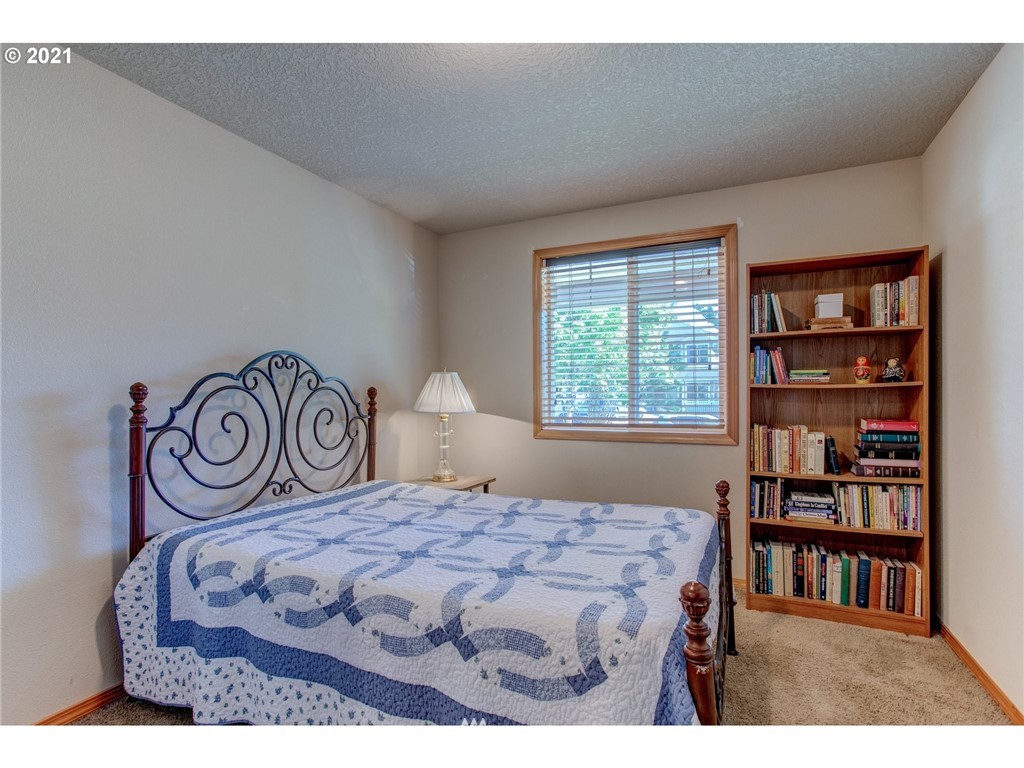 2032 North Falcon Drive Ridgefield, WA 98642 - Photo 14 of 20 a bedroom with a bed and a book shelf