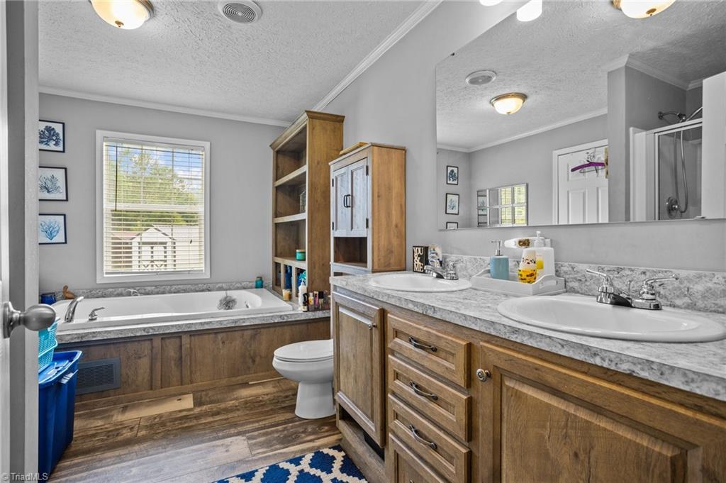 1792 Hill Road Lexington, NC 27292 - Photo 8 of 48 Ensuite primary bath with double vanity and garden tub.