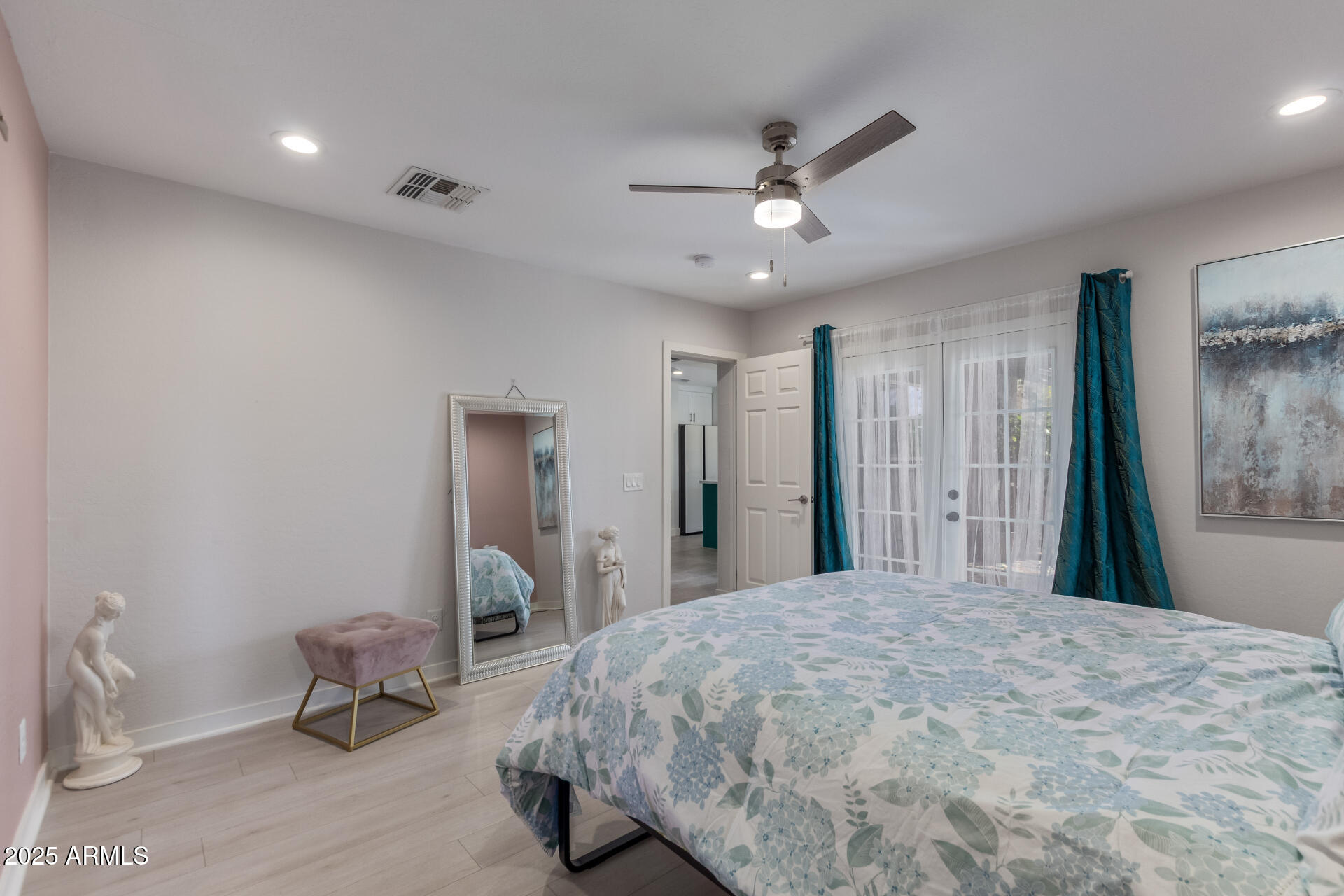 313 West Utopia Road Phoenix, AZ 85027 - Photo 11 of 59 a bedroom with a bed and a chandelier