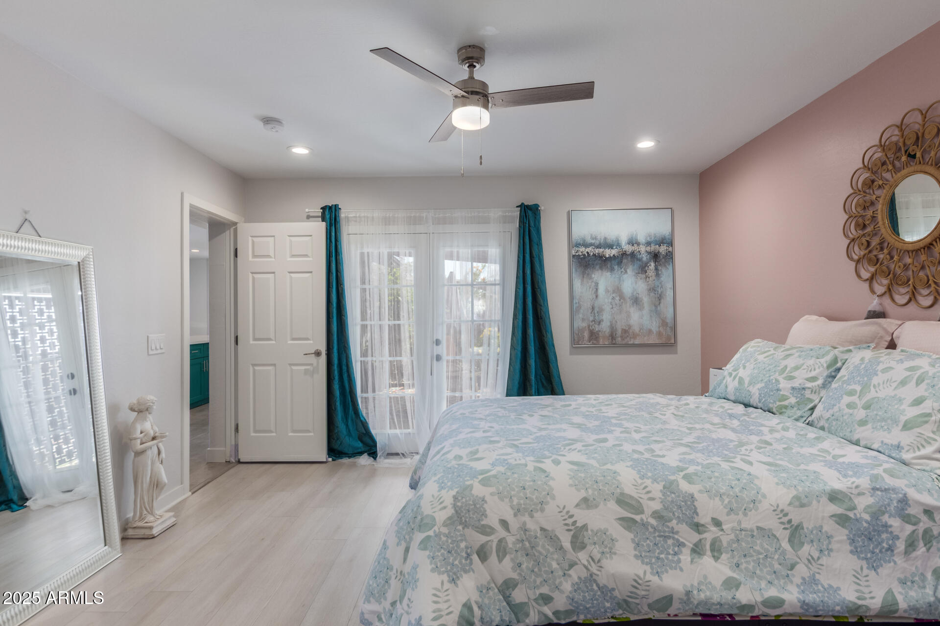 313 West Utopia Road Phoenix, AZ 85027 - Photo 12 of 59 a bedroom with a large bed and a chandelier