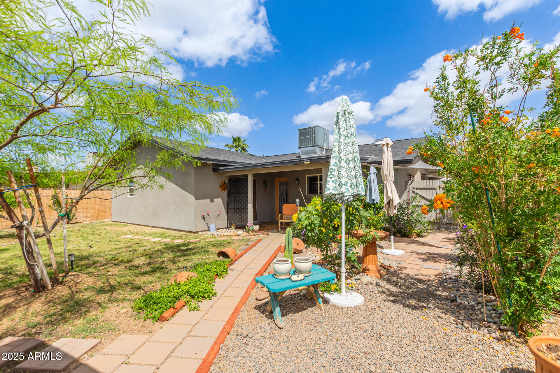 313 West Utopia Road Phoenix, AZ 85027 - Photo 25 of 59 a view of a house with patio and a yard