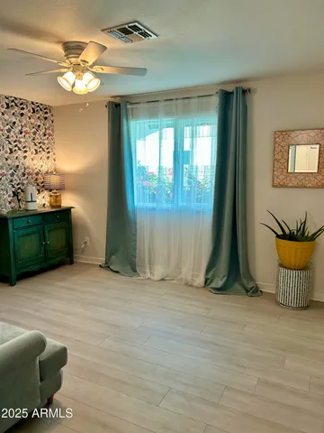 a kitchen with stainless steel appliances kitchen island granite countertop a sink a microwave a refrigerator and cabinets