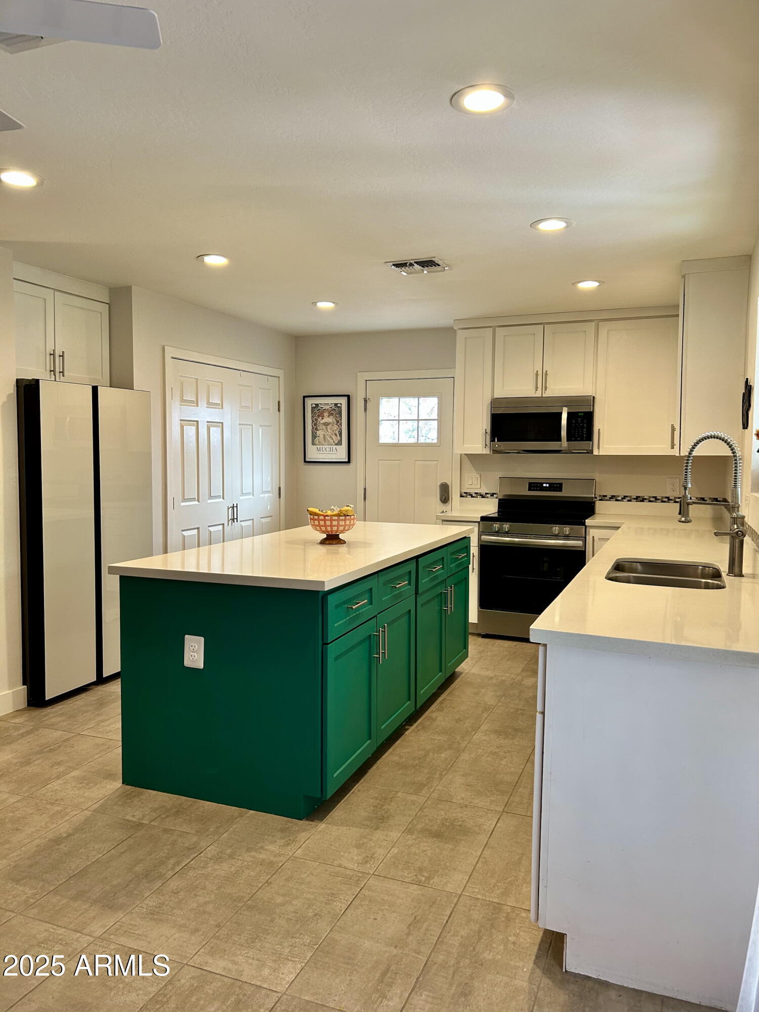 313 West Utopia Road Phoenix, AZ 85027 - Photo 49 of 59 a kitchen with kitchen island granite countertop stainless steel appliances cabinets a sink and a counter top space