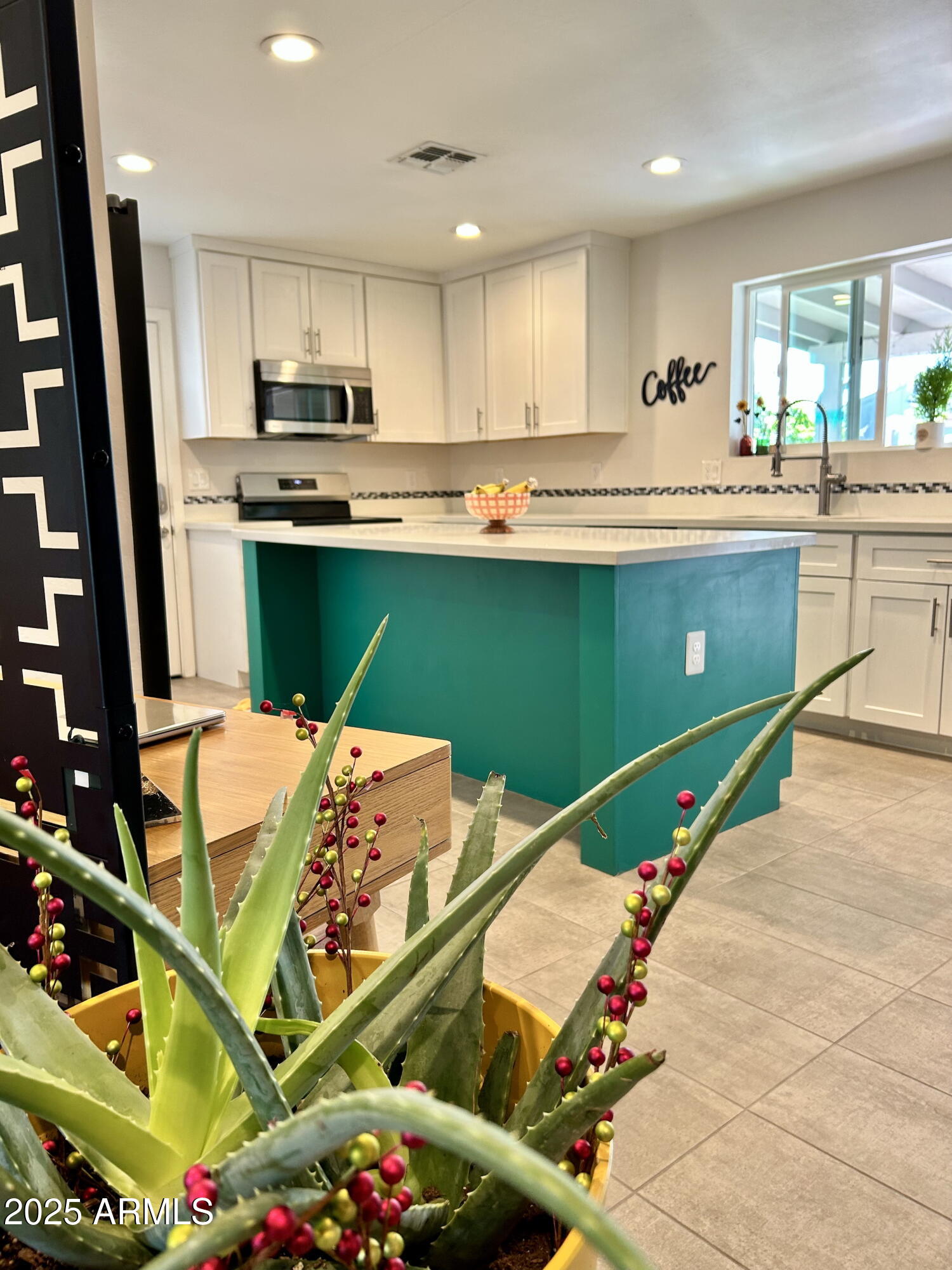 313 West Utopia Road Phoenix, AZ 85027 - Photo 50 of 59 a kitchen with stainless steel appliances kitchen island granite countertop a sink a microwave a refrigerator and cabinets