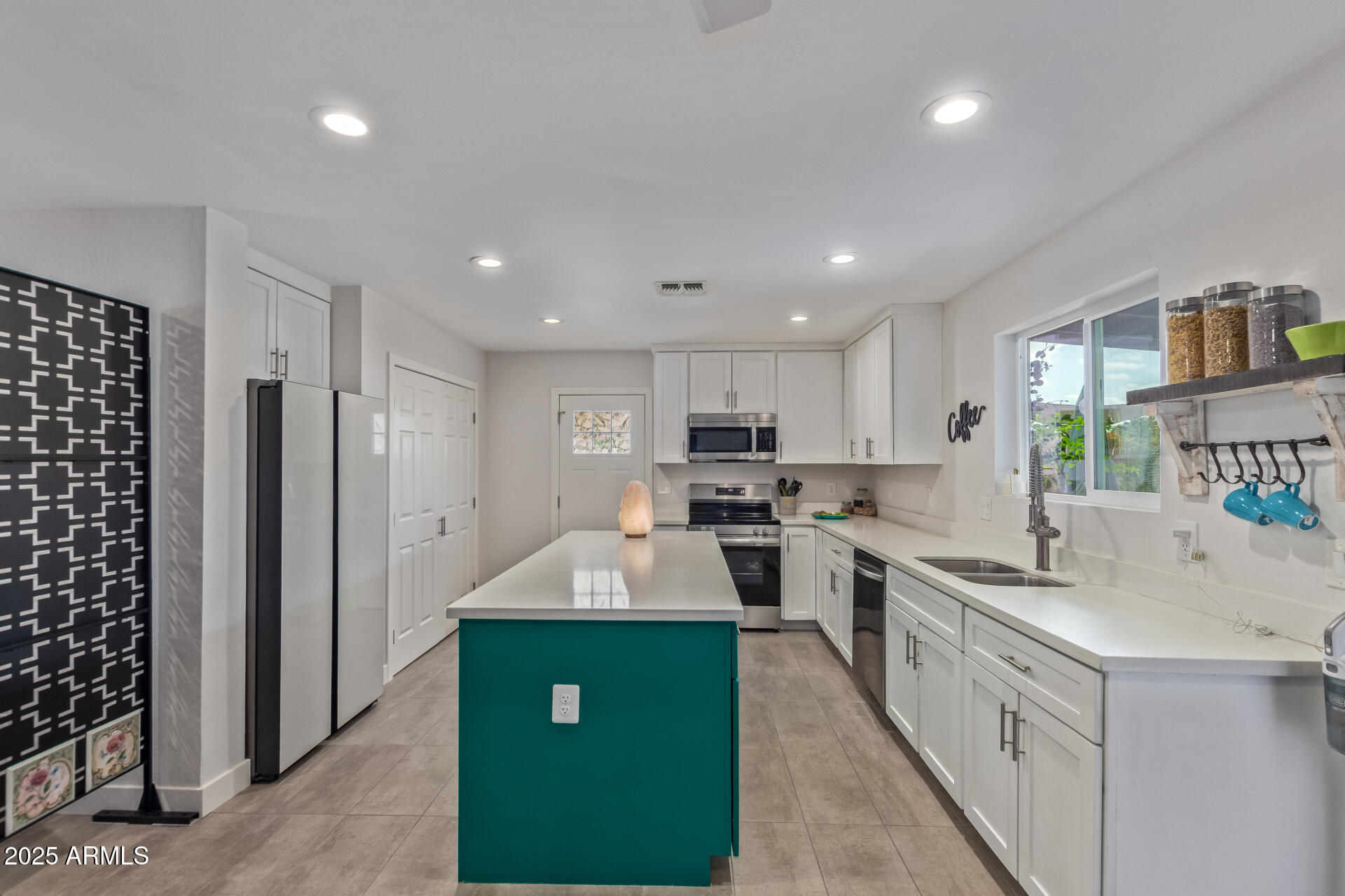 313 West Utopia Road Phoenix, AZ 85027 - Photo 6 of 59 a kitchen with white cabinets and stainless steel appliances