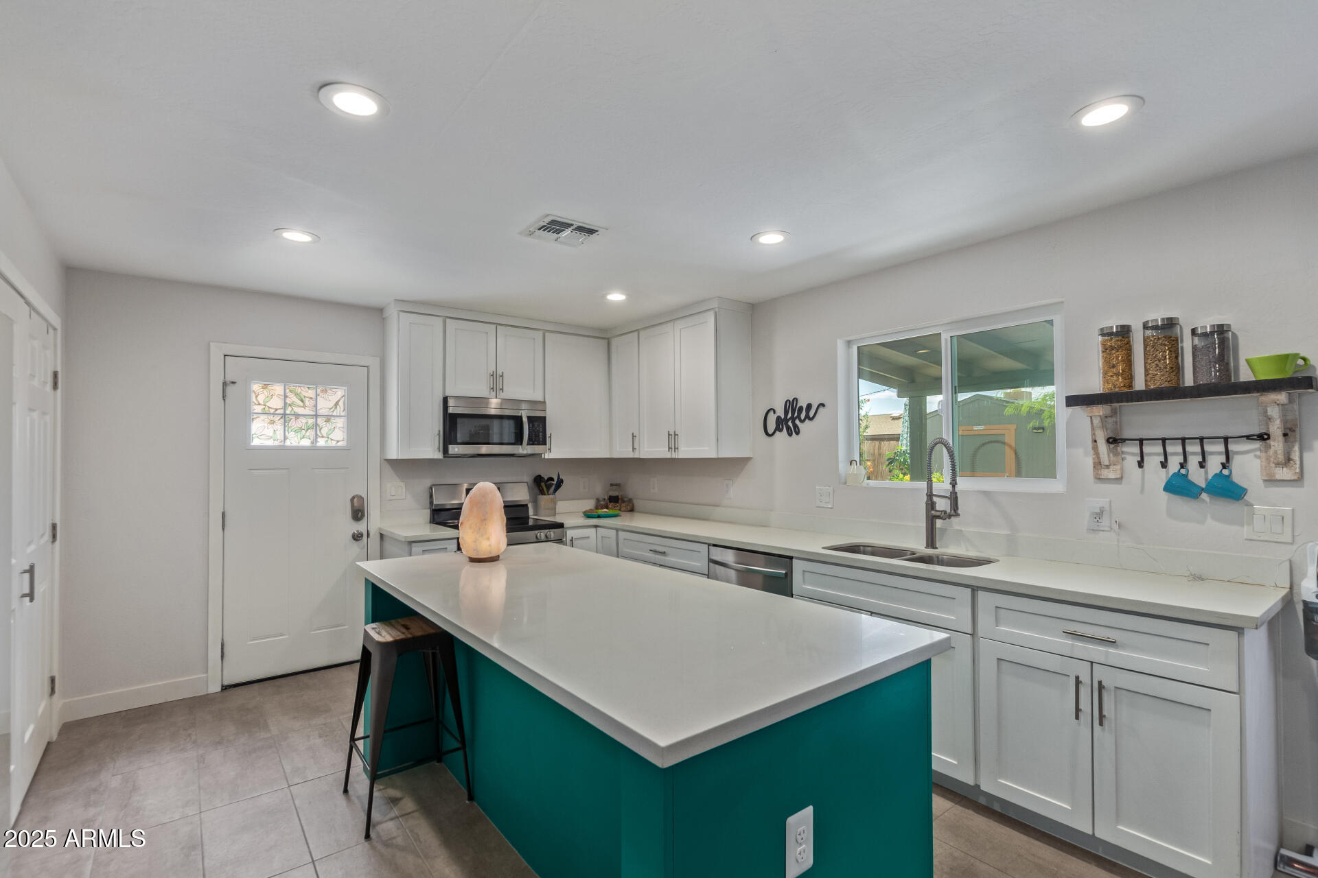 313 West Utopia Road Phoenix, AZ 85027 - Photo 7 of 59 a kitchen with a sink window and cabinets