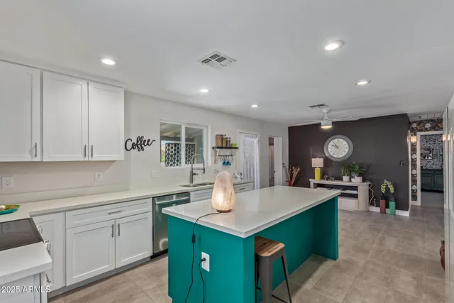 a kitchen with stainless steel appliances kitchen island a refrigerator and a stove top oven