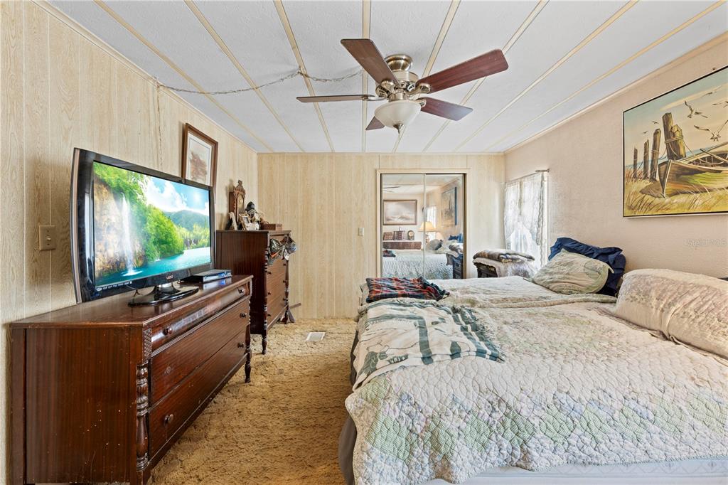 7373 Fall Street Brooksville, FL 34613 - Photo 11 of 26 a bedroom with a bed and flat screen tv