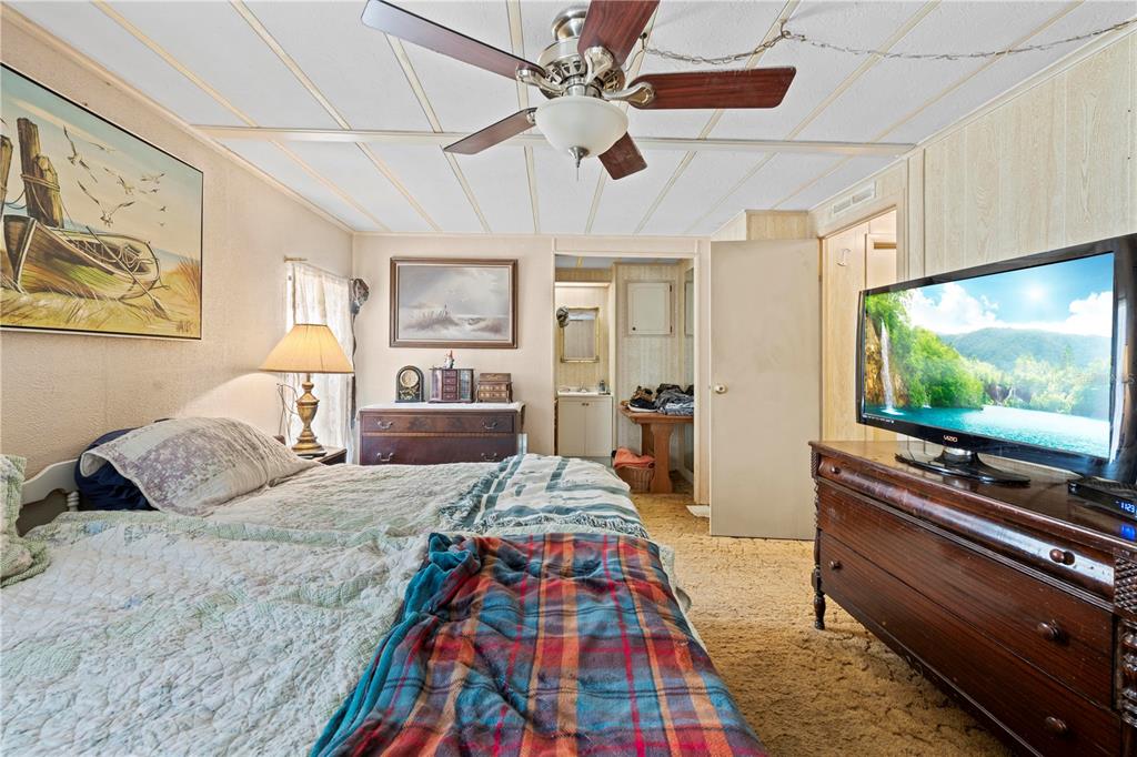7373 Fall Street Brooksville, FL 34613 - Photo 12 of 26 a bedroom with a bed and a flat screen tv