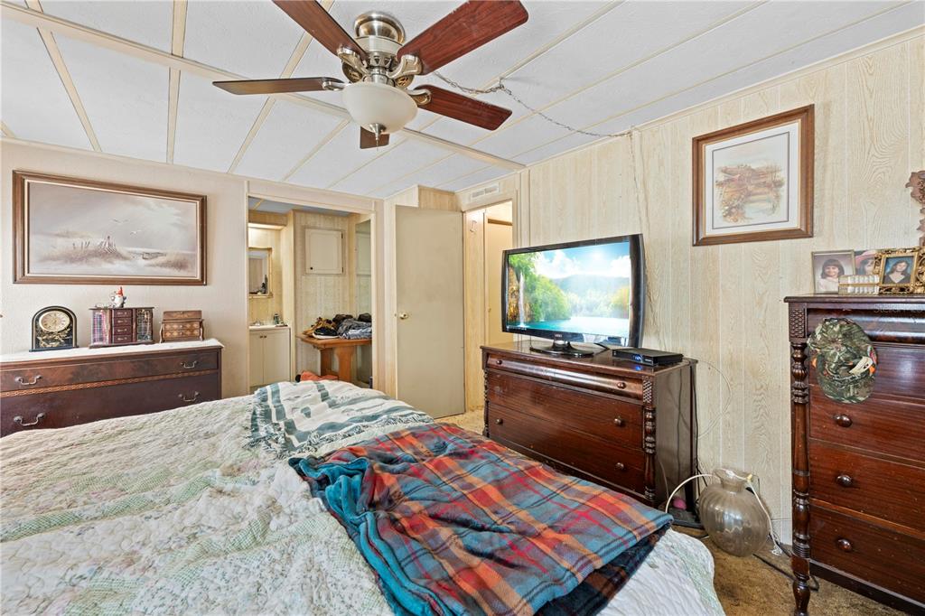 7373 Fall Street Brooksville, FL 34613 - Photo 13 of 26 a bedroom with a bed and a flat screen tv