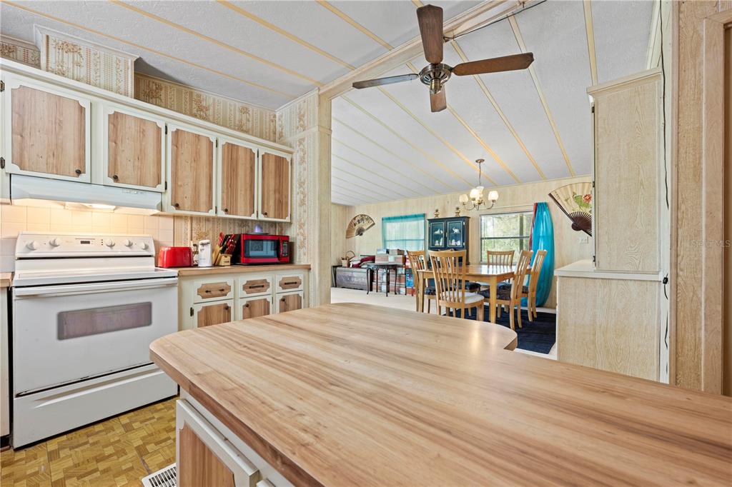 7373 Fall Street Brooksville, FL 34613 - Photo 2 of 26 a kitchen with stainless steel appliances kitchen island granite countertop a stove and cabinets
