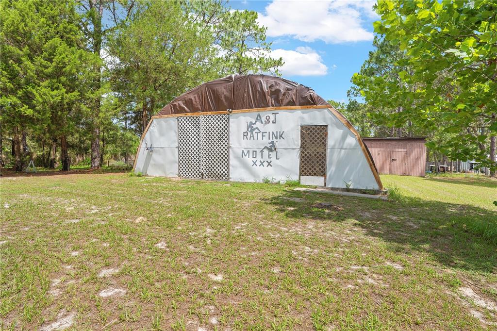 7373 Fall Street Brooksville, FL 34613 - Photo 21 of 26 a front view of a house with garden