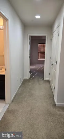 an empty room with a fireplace and cabinet