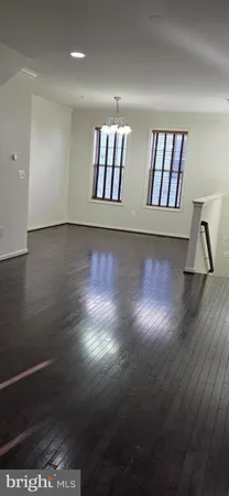 a view of wooden floor and windows in a room