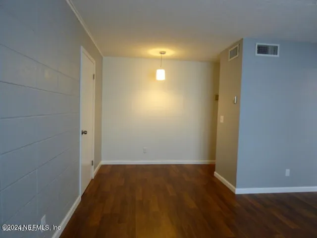 a view of a room with wooden floor