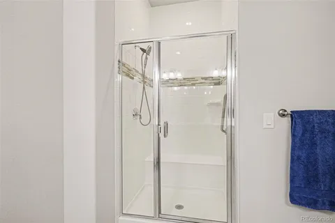 a bathroom with a glass shower door